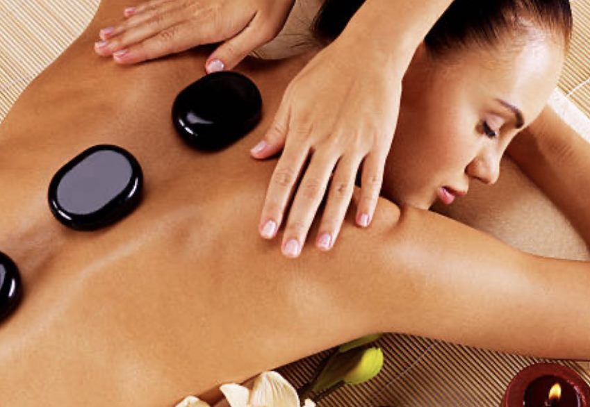 Hot stone massage with heated volcanic stones placed along the back in Athlone